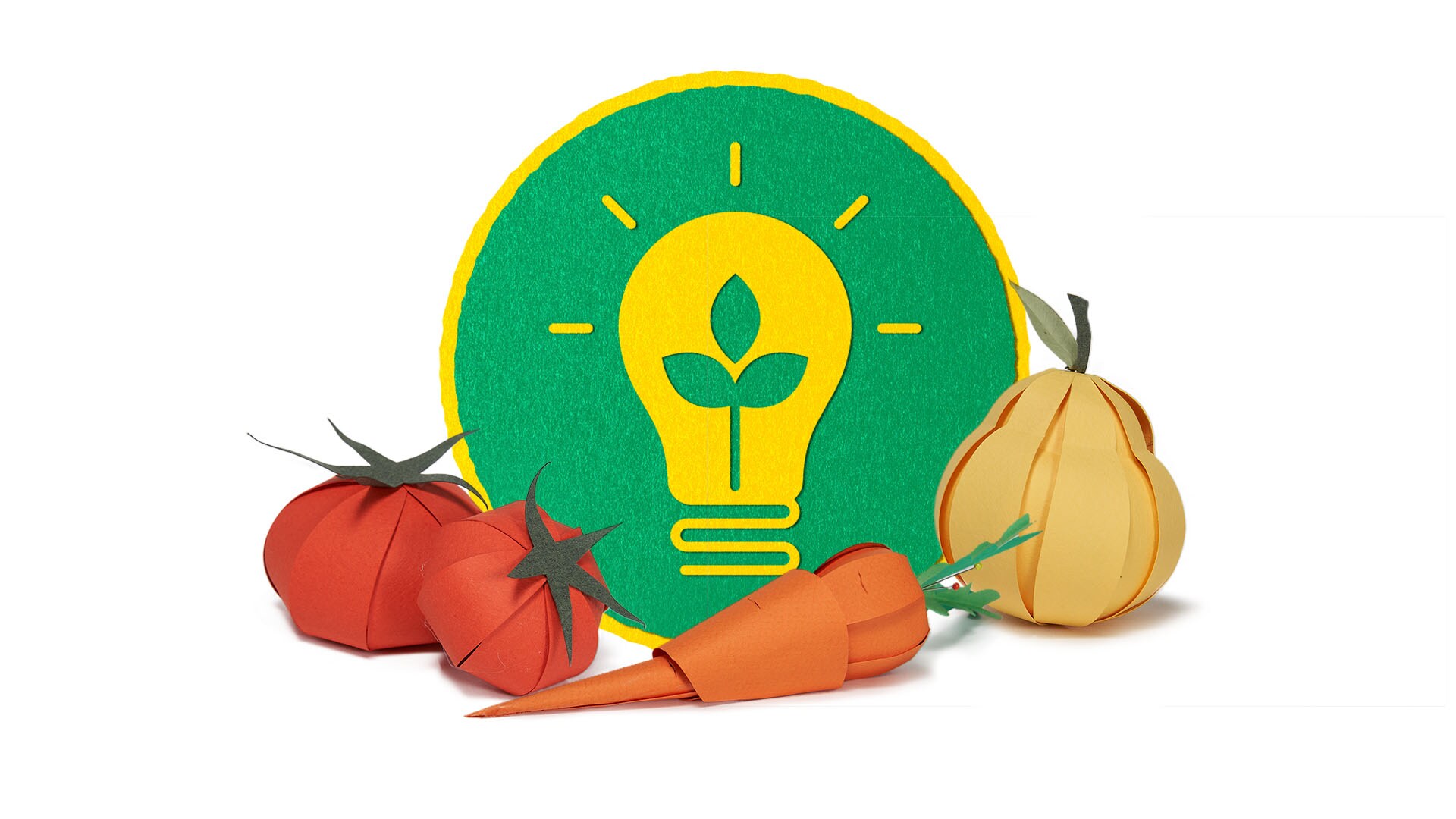 Obst und Gemüse aus Papier vor einem Icon für grüne Energie