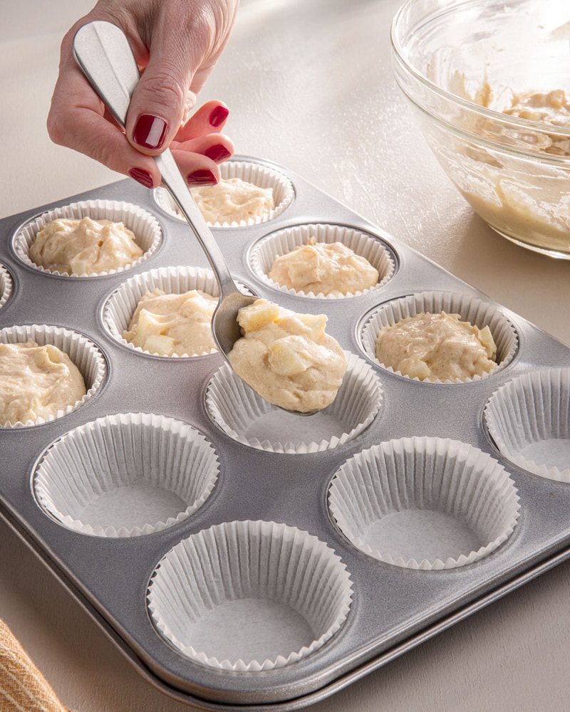 Dieses Bild zeigt wie der Teig in die Muffinförmchen gegeben wird.
