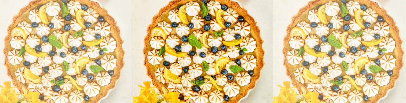 Dieses Bild zeigt die fertige Zitronentarte mit Baiser-Tuffs und Blaubeeren. 