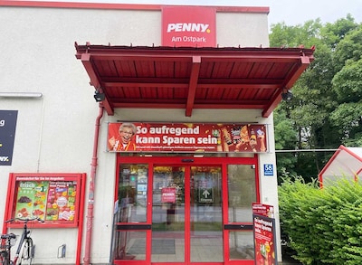 Sie sehen den Eingang vom Penny Markt in Muenchen/Ramersd.-Perlach, Quiddestr. 58