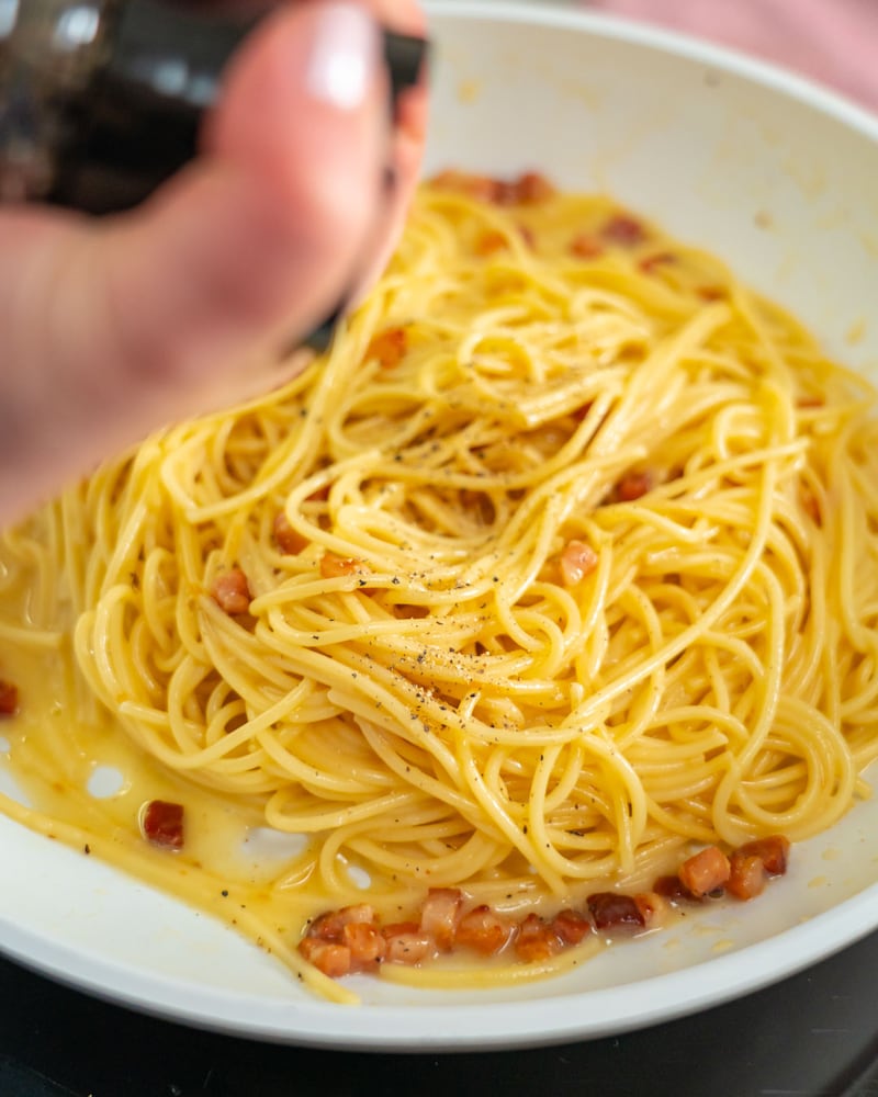 Diese Bild zeigt das Würzen der Spaghetti Cabonara.
