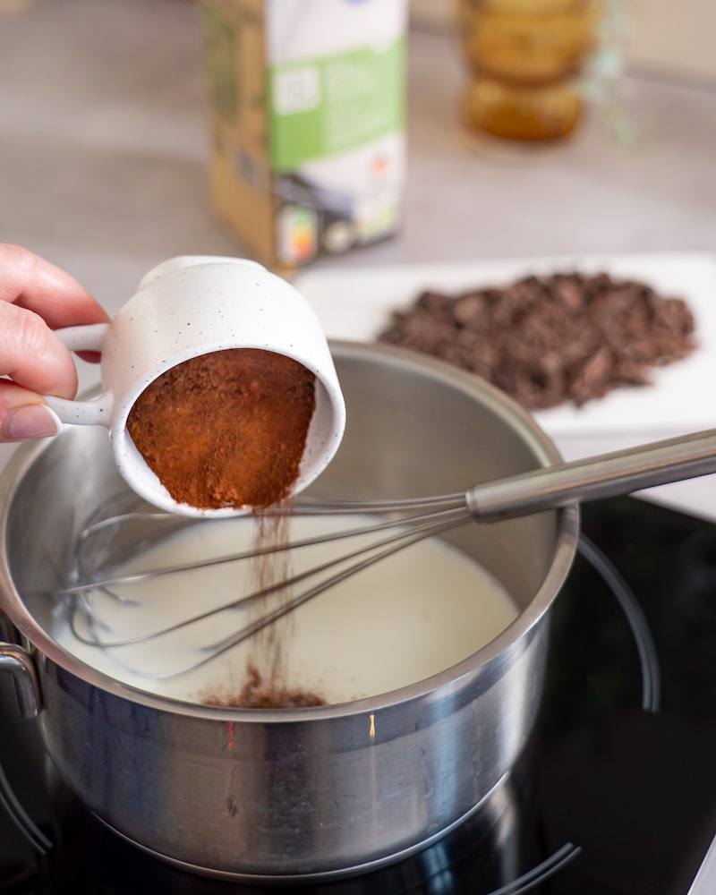 Dieses Bild zeigt wie der Kakao zu der Milch gegeben wird.