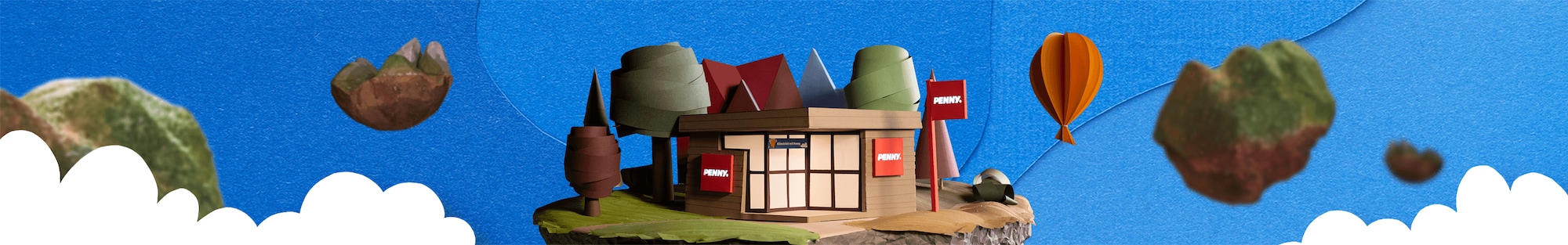 Ein PENNY Markt im Papierlook mit Wolken und Bäumen