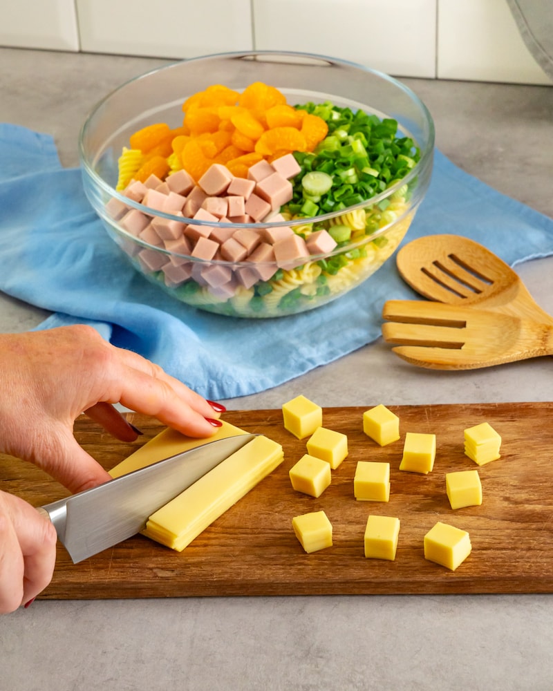 Dieses Bild zeigt wie der Käse gewürfelt wird.