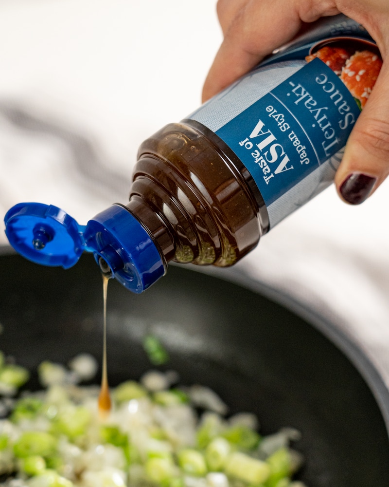 Auf diesem Bild siehst du wie Teriyaki-Soße dazugegeben wird.