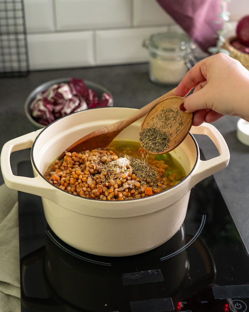Dieses Bild zeigt das würzen der Linsensuppe.