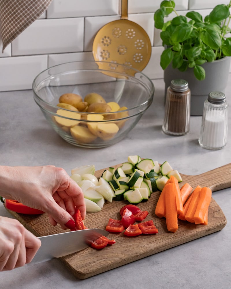 Dieses Bild zeigt, wie das Gemüse geschnitten wird.