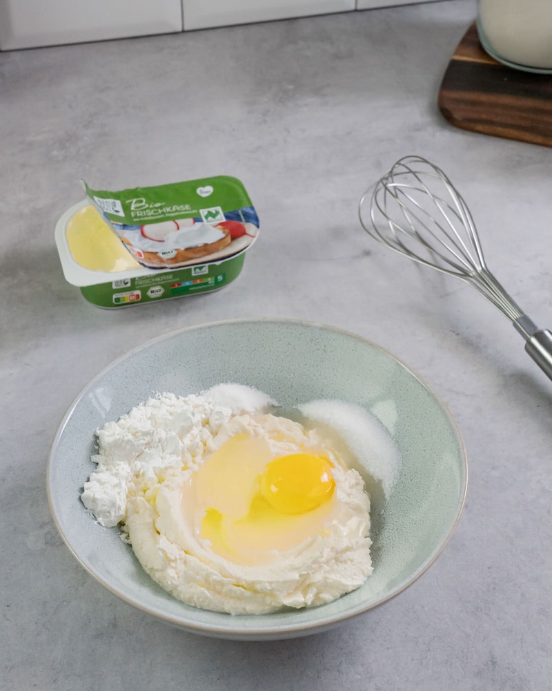 Dieses Bild zeigt, wie Frischkäse und Ei vermischt werden.