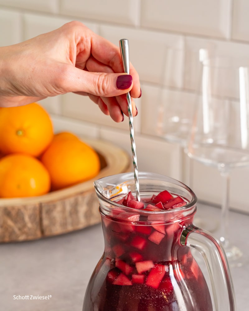 Dieses Bild zeigt wie der Sangria umgerührt wird.