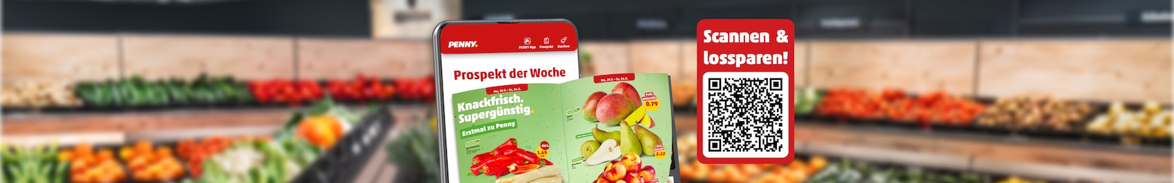 Ein Handy mit Blätterprospekt vor PENNY Marktregalen 