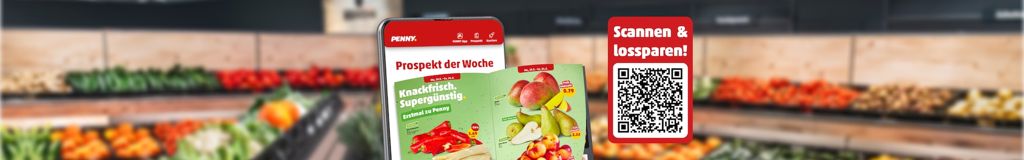 Ein Handy mit Blätterprospekt vor PENNY Marktregalen 