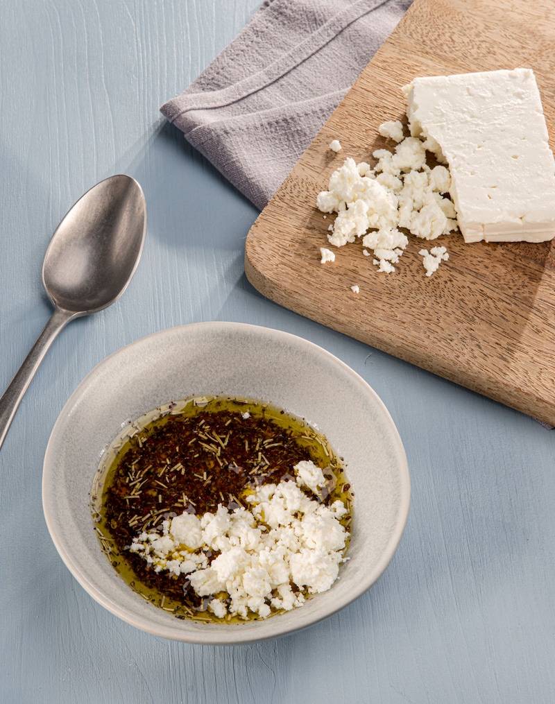 Dieses Bild zeigt wie der Feta in die Würzmischung gegeben wird.