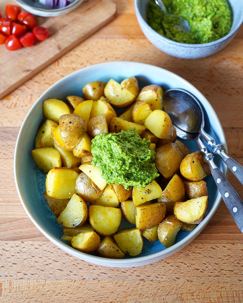 Dieses Bild zeigt wie das Pesto auf die Kartoffeln gegeben wird.
