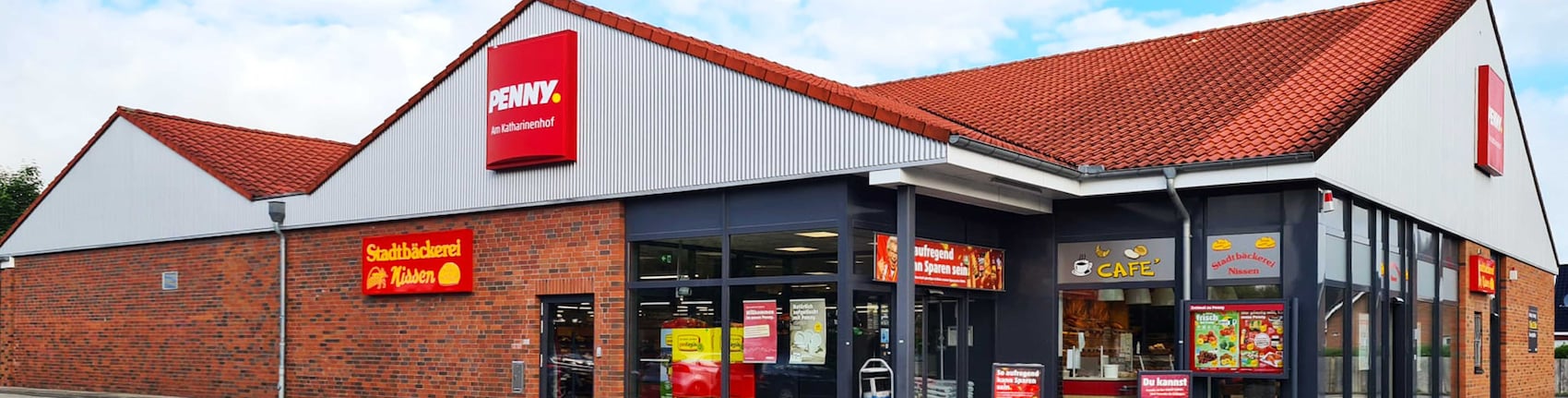 Sie sehen den Eingang vom Penny Markt in Flensburg Am Katharinenhof 30