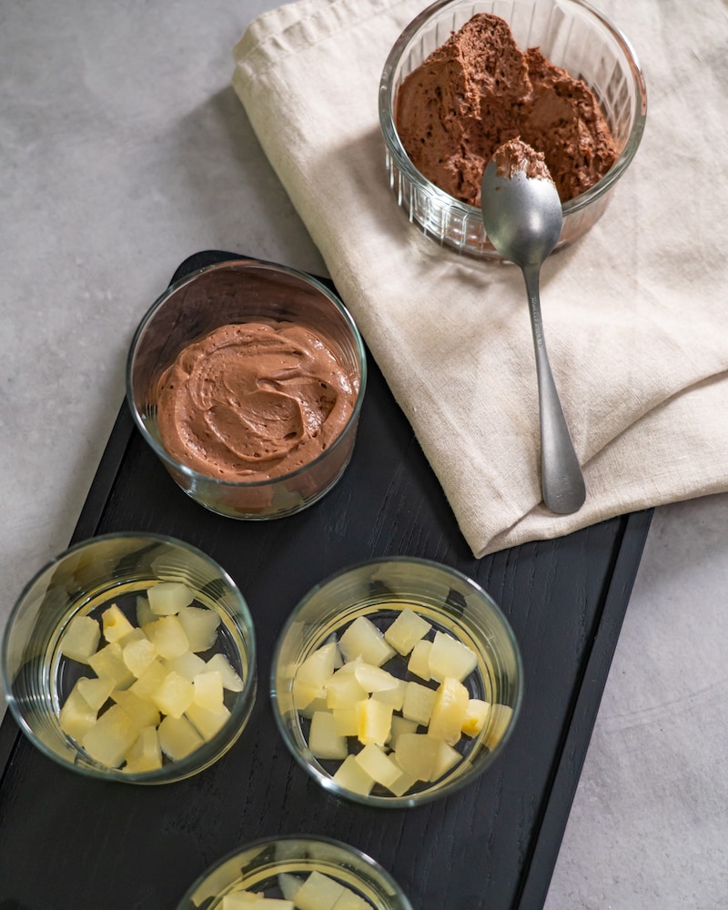 Dieses Bild zeigt wie das Mousse auf die Birnen verteilt werden.