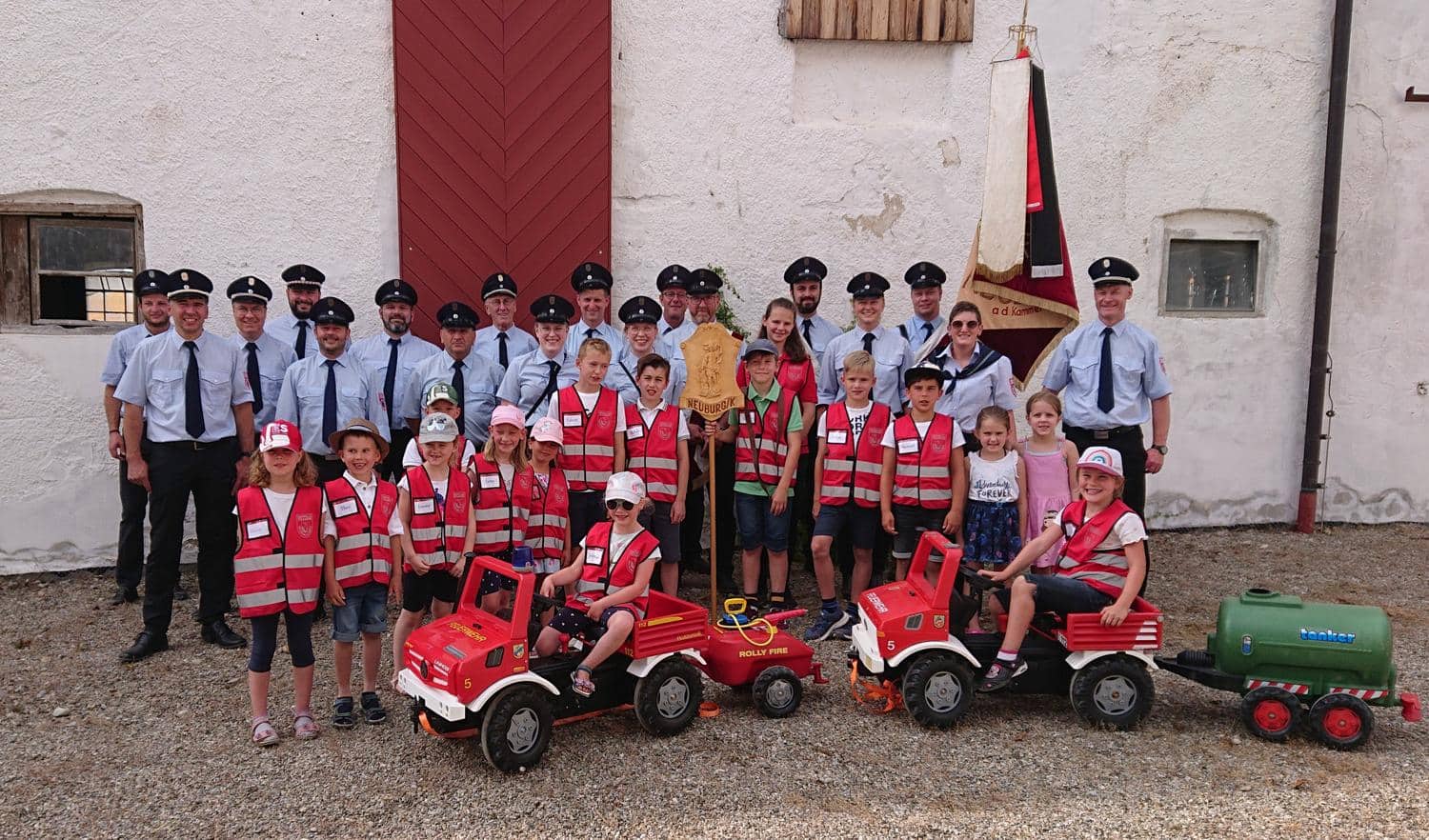 Vereinsmitglieder und Kinder in Uniform bei der Feuerwehr