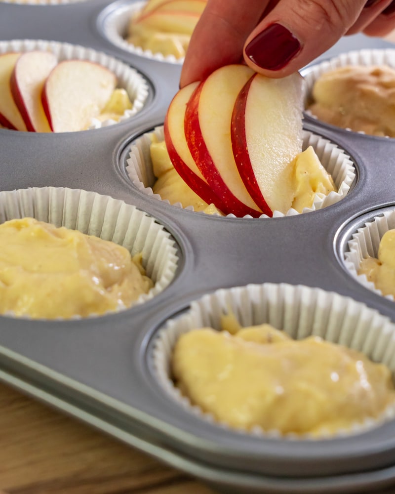 Dieses Bild zeigt wie der Apfel auf den Muffin gegeben wird.