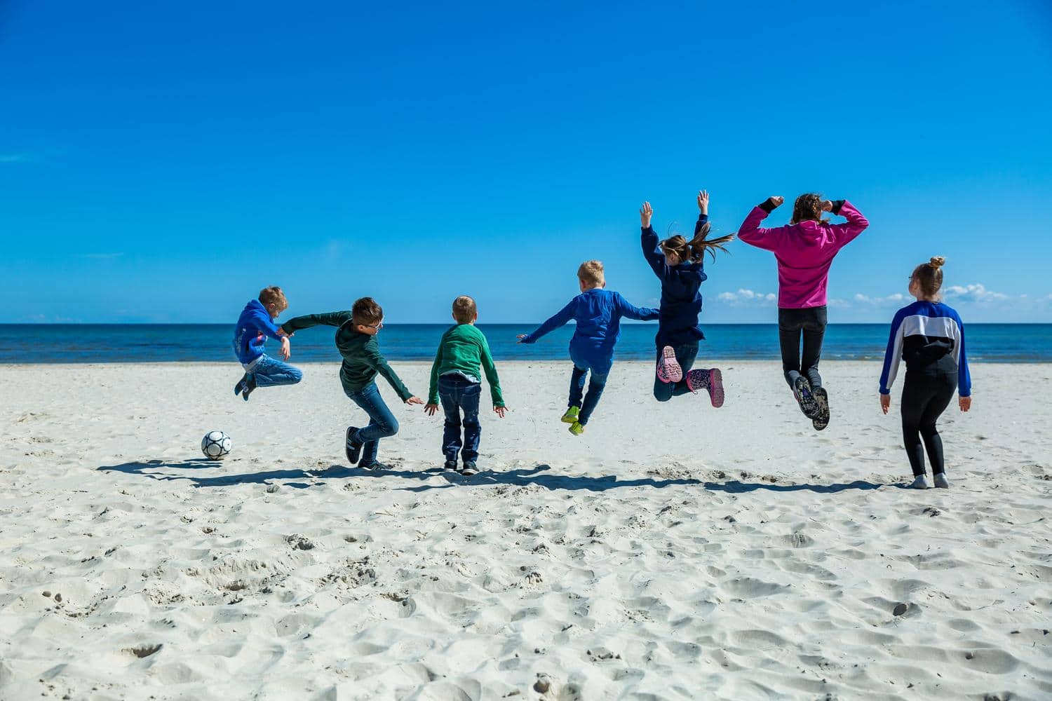 Kinder toben sich am Strand aus