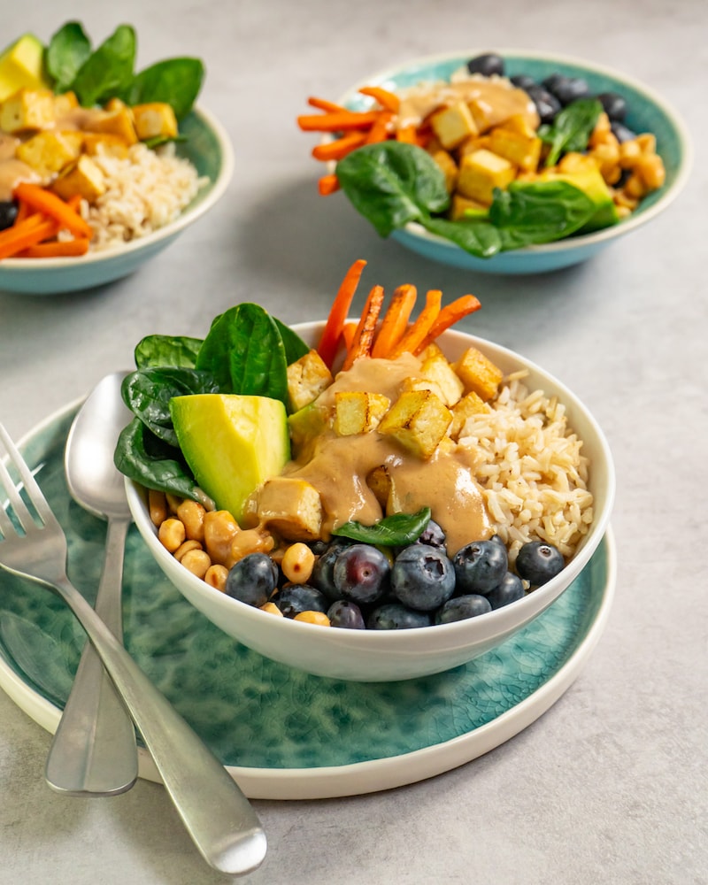 Dieses Bild zeigt die fertige Buddha-Bowl mit Tofu, Reis und Erdnusssauce.