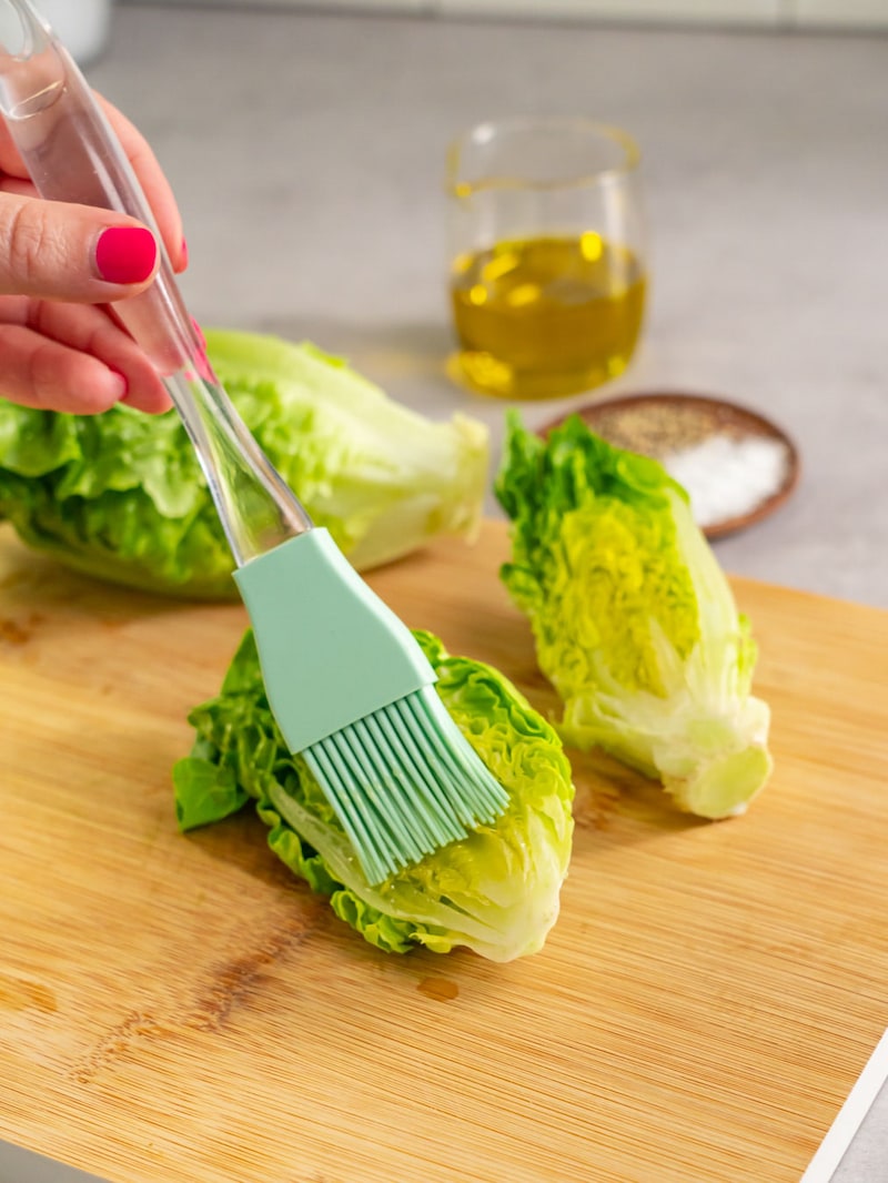 Dieses Bild zeigt wie der Salat mit Öl bestrichen wird.